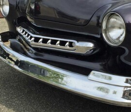 1949 Black Mercury front 3/4 portrait shot displaying bumper, custom fabricated grille, and headlight rings restoration, polishing, and chrome plating performed by Spacecoast Plating.