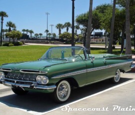 1959 Chevrolet Impala convertible (green) front 3/4 shot displays bumper, grille, headlight rings, emblem, hood and fender trim, windshield and window and door trim, mirrors, aluminum quarter panel and fender spears, full-disc wheel covers, and emblems restored and chrome plated by Spacecoast Plating.