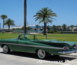 1959 Chevrolet Impala convertible (green) rear driver side 3/4 shot displays bumper, taillight surrounds, trunk and batwing fin trim, emblem, antennas, windshield trim, door trim, mirrors, aluminum quarter panel trim, and fender spears restored and chrome plated by Spacecoast Plating.