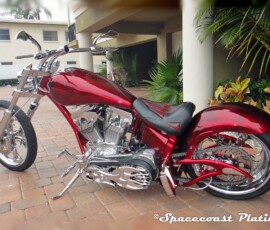 This early 2000s Custom Chopper Motorcycle features a striking candy red paint job and heavy chrome detailing, showcasing Spacecoast Plating's custom chrome work.