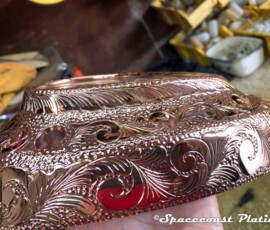 Side view of chrome plated custom motorcycle engine component.